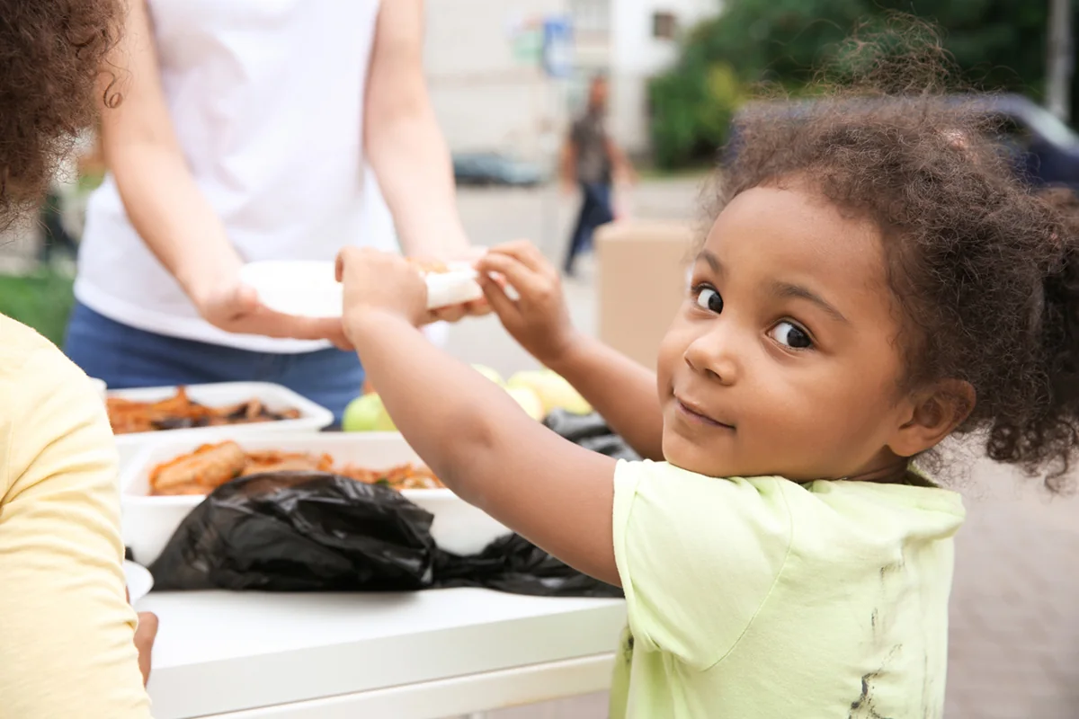 A young student smiling during a community program