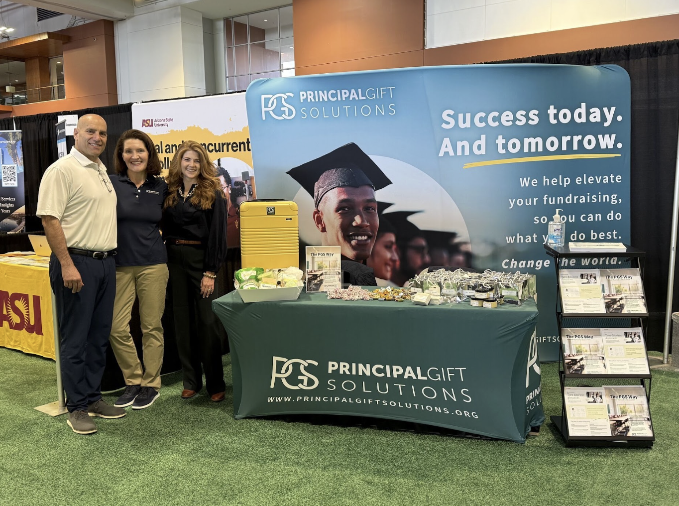 Three Principal Gift Solutions team members at the PGS conference booth