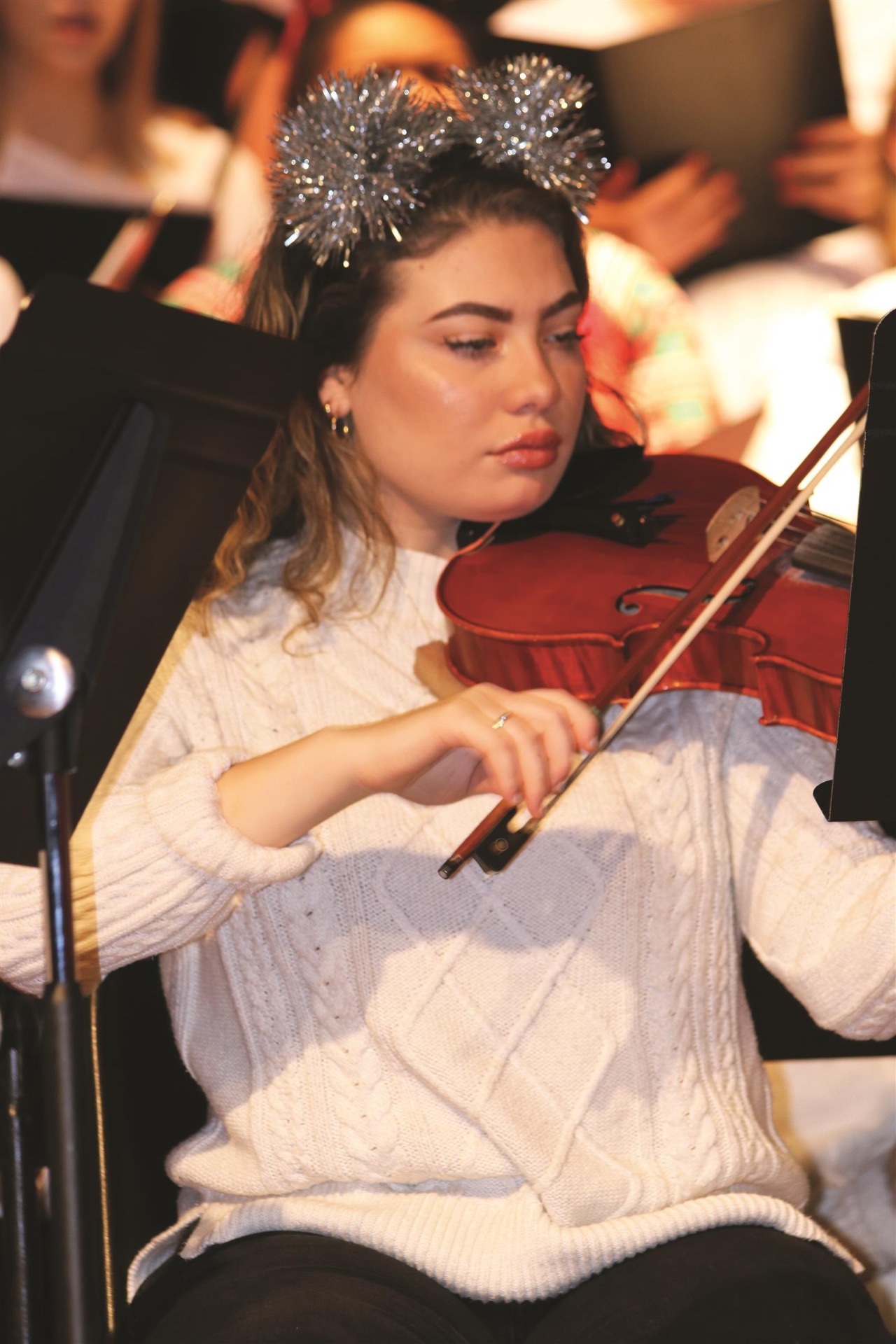 St. Thomas More student playing violin during a fine arts performance