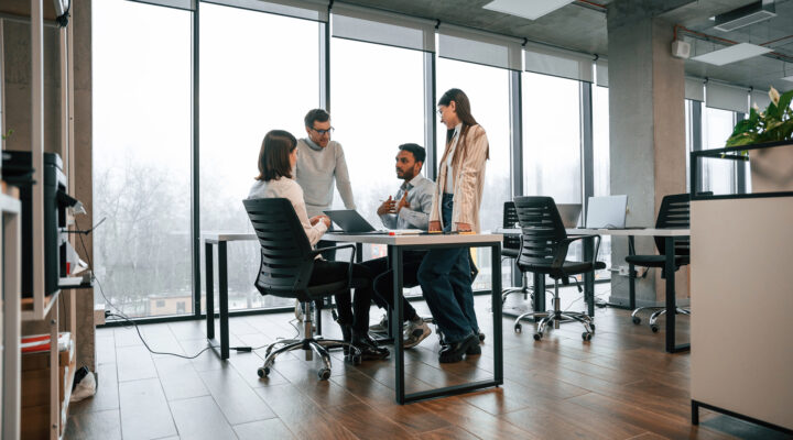 Four people working in an office together